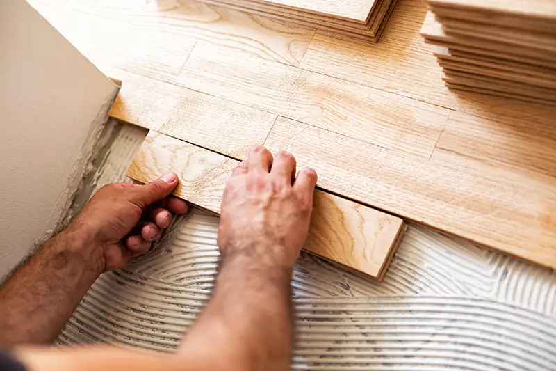 Worker installing hardwood flooring | Chillicothe Carpet