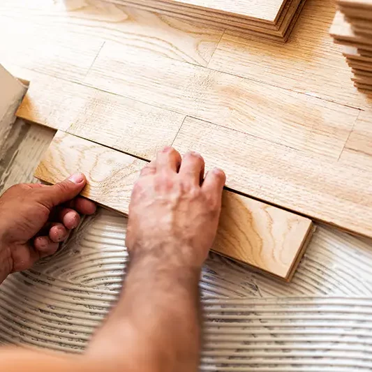 Worker installing hardwood flooring | Chillicothe Carpet